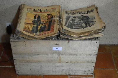 two old newspapers sitting on top of a wooden box