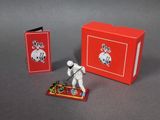a toy figure that is standing in front of a red box