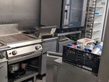 a kitchen with a stove, oven, and refrigerator in it