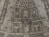 a silver plate with designs on it on a white surface