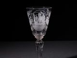 a wine glass that is sitting on a table
