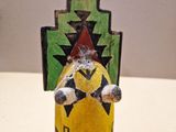 a small figurine of a man sitting on top of a table