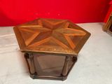 an image of a small wooden table with a star design on it