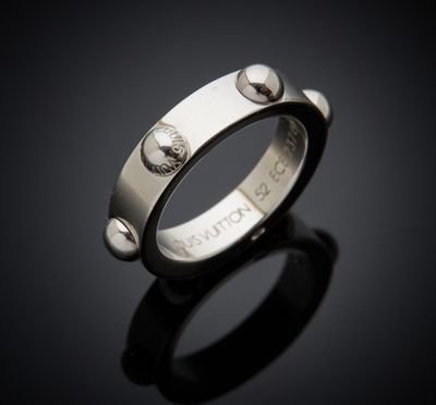 a close up of a silver ring on a black surface