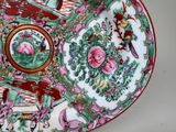 a decorative plate with birds and flowers on it