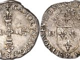 a silver coin with a shield on the front and a shield on the back