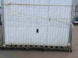 a large white box on a pallet in a parking lot