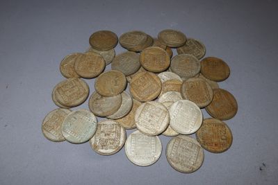 a pile of old coins sitting on a table
