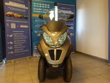 a scooter that is parked in front of a blue wall