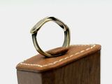 a wooden box with a ring on top of it