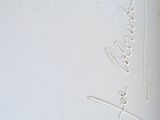 a picture of a white vase with writing on it