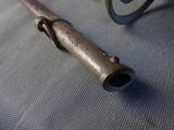a small metal object on a table with a pair of glasses