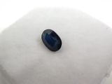 a close up of a blue sapphire stone on a white surface