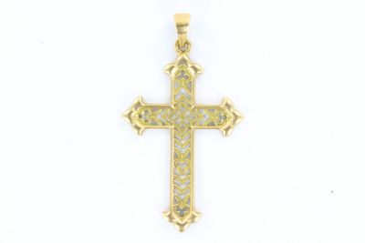un gros plan d'une croix sur une surface blanche avec un fond blanc