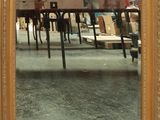 a picture of a mirror that is on the wall
