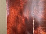 a close up of a clock on a wooden table