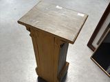 a wooden table with a picture frame on it in the middle of a room