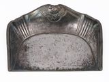 an antique silver plate with a lion head on top of it