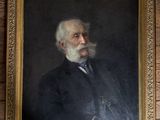 portrait of an old man with a white beard and a black suit