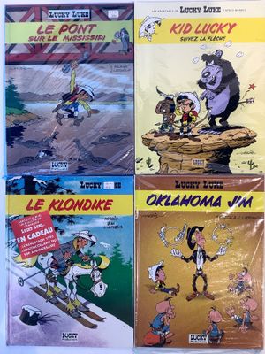 four cartoon books on display on a table in front of a white background