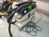 two vacuums that are sitting on the floor