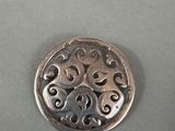 a silver coin that is sitting on a table