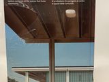 the back cover of a book with a picture of a house in the background