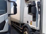 two trucks parked next to each other in a parking lot