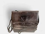 brown leather purse on white background with strap and shoulder strap