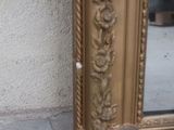 a mirror that is sitting on the ground near a wall