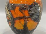 a vase that is sitting on a white surface