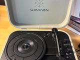a record player sitting in a suitcase on a table