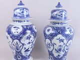 pair of blue and white vases with lids on a white background