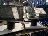 two laptops sitting on top of a table in a warehouse