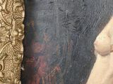 painting of a nude woman in a gold frame with a black background