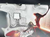 a picture of a woman sitting in a bed with a gun
