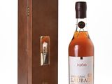 a bottle of liquor sitting next to a wooden box