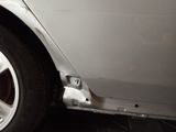 a close up of a white car with a flat tire