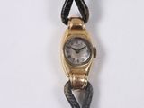 a gold wrist watch with a snake on it