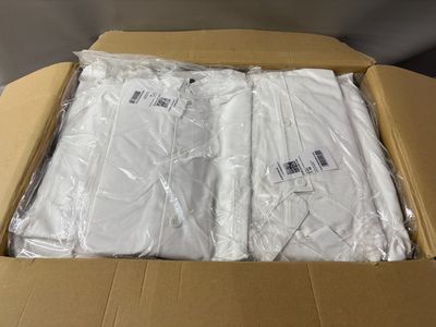 a cardboard box filled with white t - shirts on a table