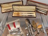 many different types of utensils and spoons in a display case