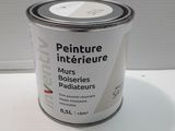 a can of paint sitting on a white table