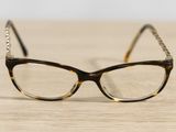 a pair of glasses sitting on a wooden table