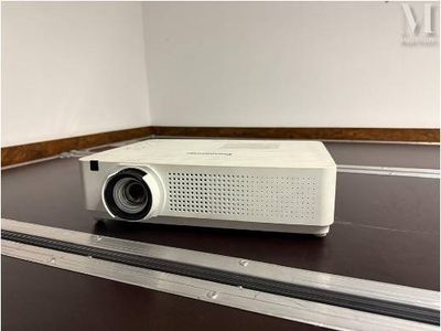 a white projector sitting on a table in a room