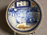 a blue and white plate with a picture on it