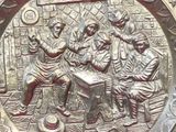 a metal plaque with a group of people on it