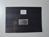 an envelope with a stamp on it sitting on top of a table