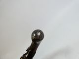 a close up of a metal object on a white surface