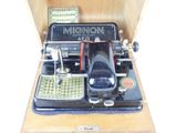 a black typewriter with a wooden box on top of it