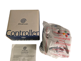 a box with a controller in it next to a package